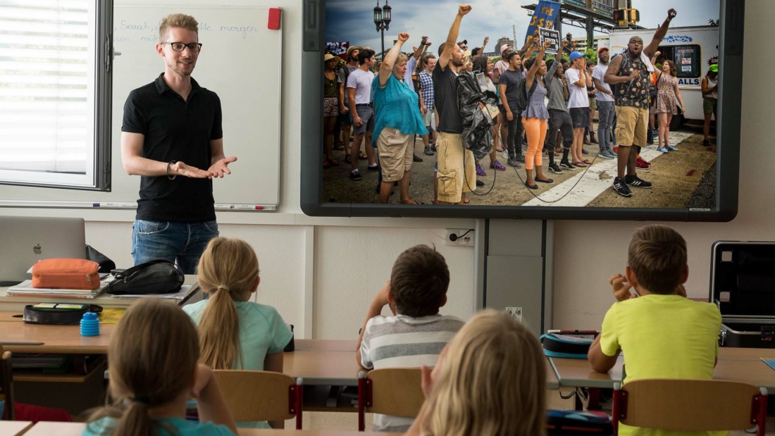 children in a classroom discussing current events