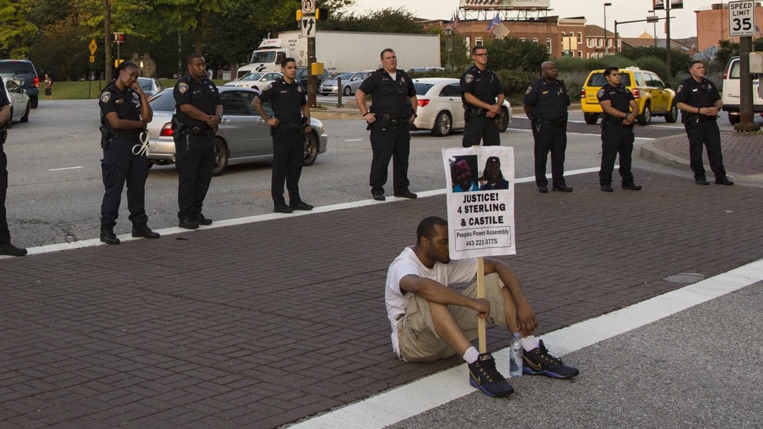 man protesting by police