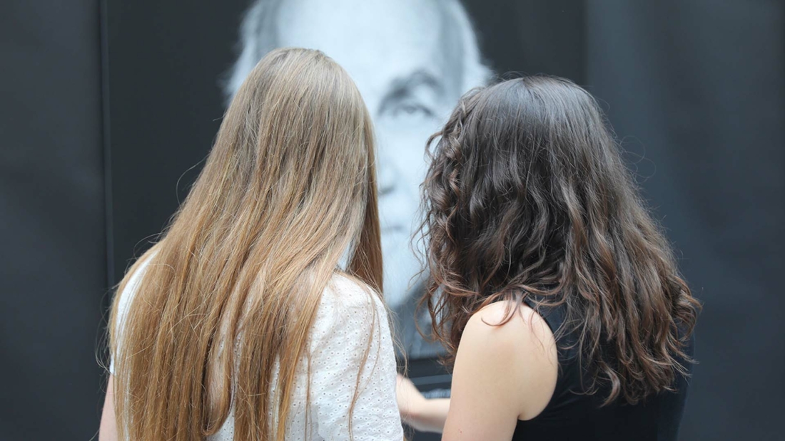 two young women discussing an exhibit
